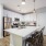 pendant lights over island in open, corner kitchen